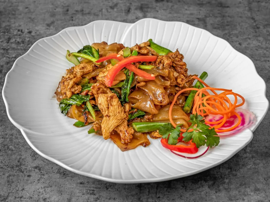 Pad see ew with wide rice noodles, chicken and Chinese broccoli at Thai Food Near Me NYC