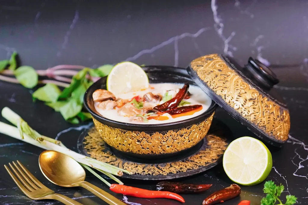 Tom kha gai coconut chicken soup with lime, lemongrass and chili oil at Thai Food Near Me NYC